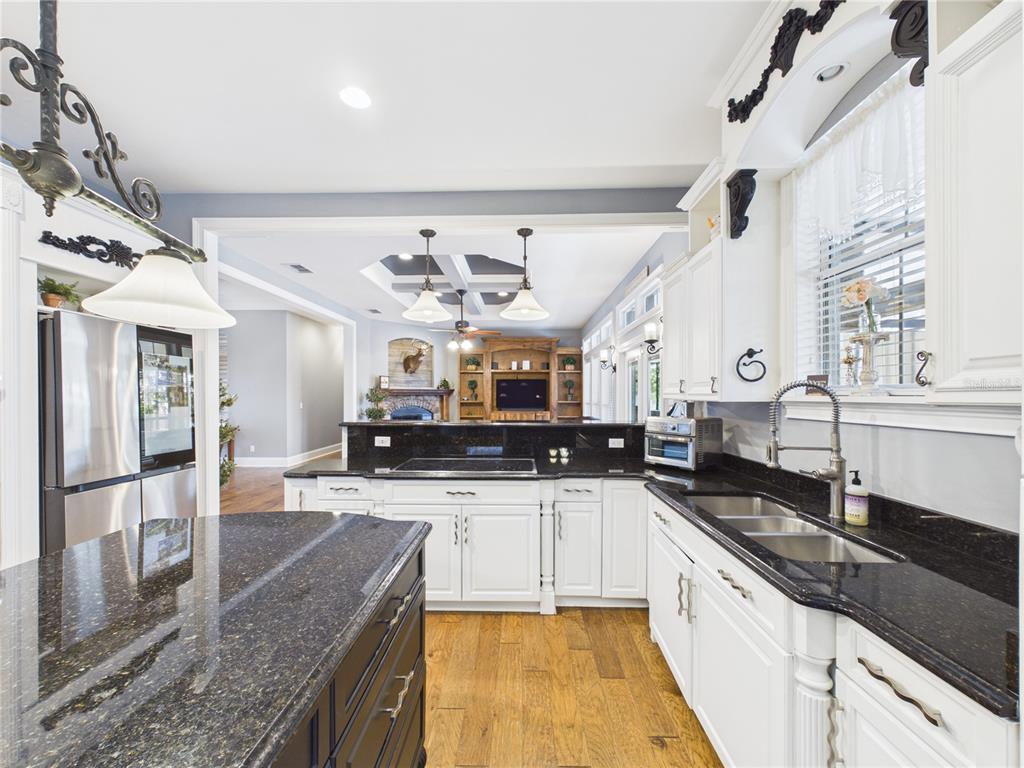 2215 Southwest 80th Street Ocala, FL 34476 - Photo 14 of 64 a large kitchen with stainless steel appliances granite countertop a sink and cabinets