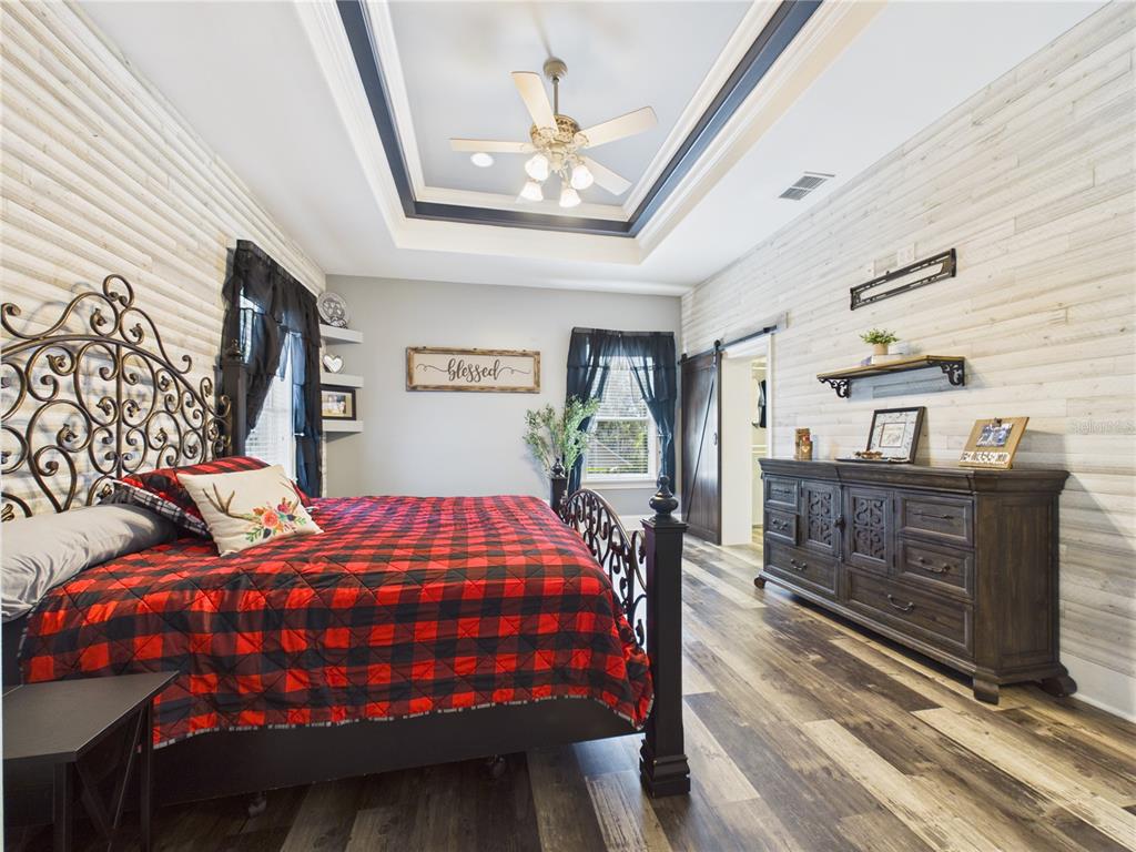 2215 Southwest 80th Street Ocala, FL 34476 - Photo 20 of 64 a bedroom with bed and wooden floor