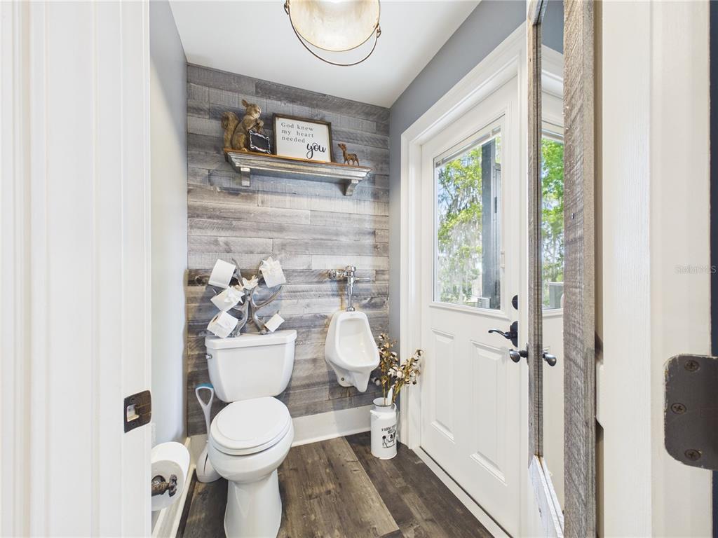 2215 Southwest 80th Street Ocala, FL 34476 - Photo 24 of 64 a white toilet sitting next to a bathroom sink