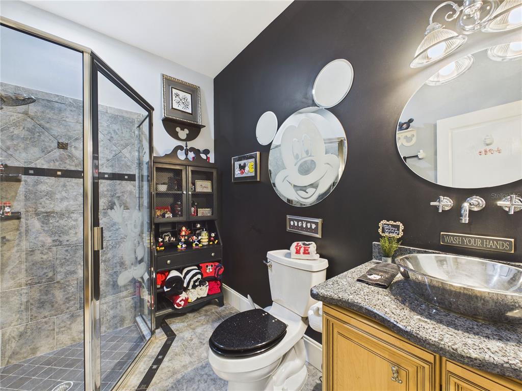 2215 Southwest 80th Street Ocala, FL 34476 - Photo 33 of 64 a bathroom with a granite countertop sink mirror vanity and toilet
