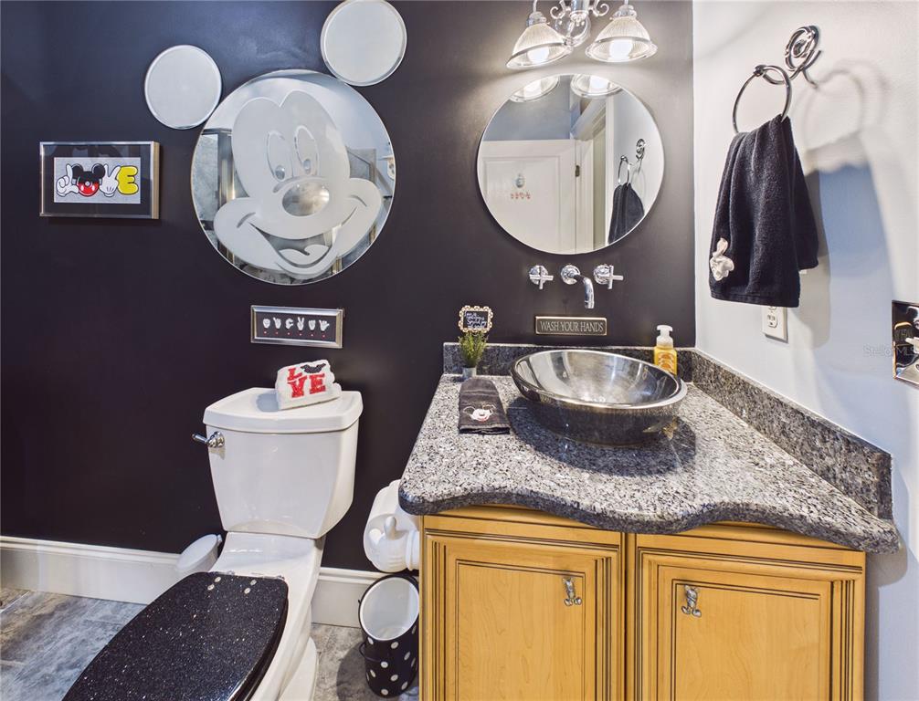 2215 Southwest 80th Street Ocala, FL 34476 - Photo 34 of 64 a bathroom with a toilet a sink and a mirror