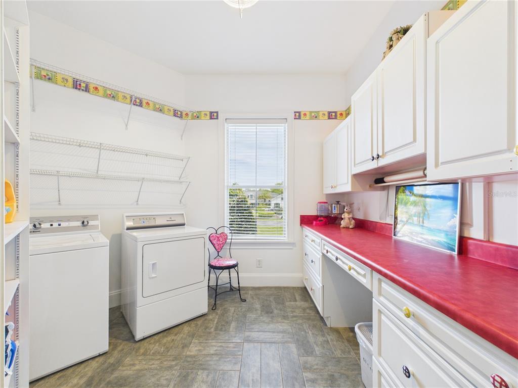 2215 Southwest 80th Street Ocala, FL 34476 - Photo 38 of 64 a kitchen with a stove a sink dishwasher and white appliances with wooden cabinets