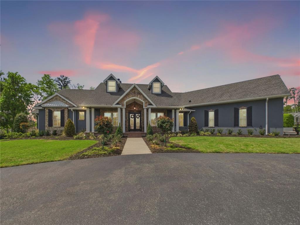 2215 Southwest 80th Street Ocala, FL 34476 - Photo 4 of 64 a front view of a house with a yard