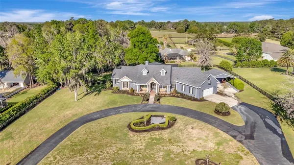 a aerial view of a house with swimming pool garden and patio