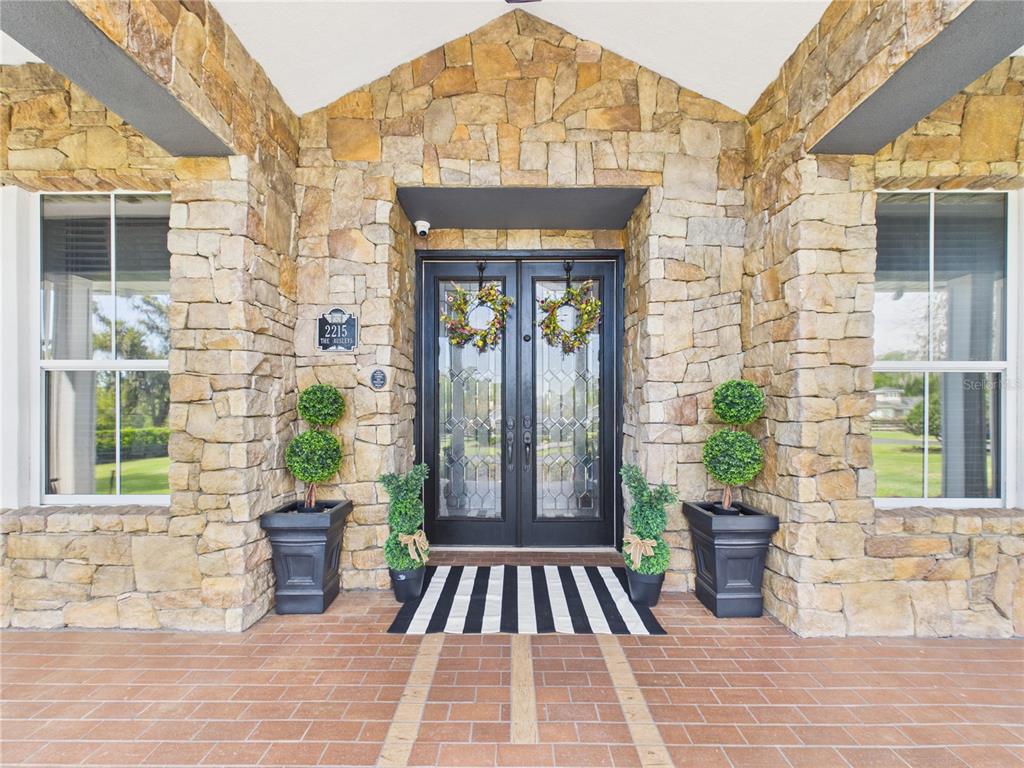 2215 Southwest 80th Street Ocala, FL 34476 - Photo 6 of 64 a front view of a house with outdoor seating