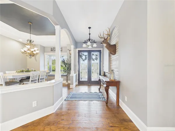 a view of a dining room with furniture wooden floor and chandelier