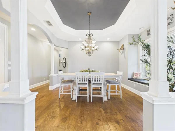 a view of a dining room with furniture and wooden floor