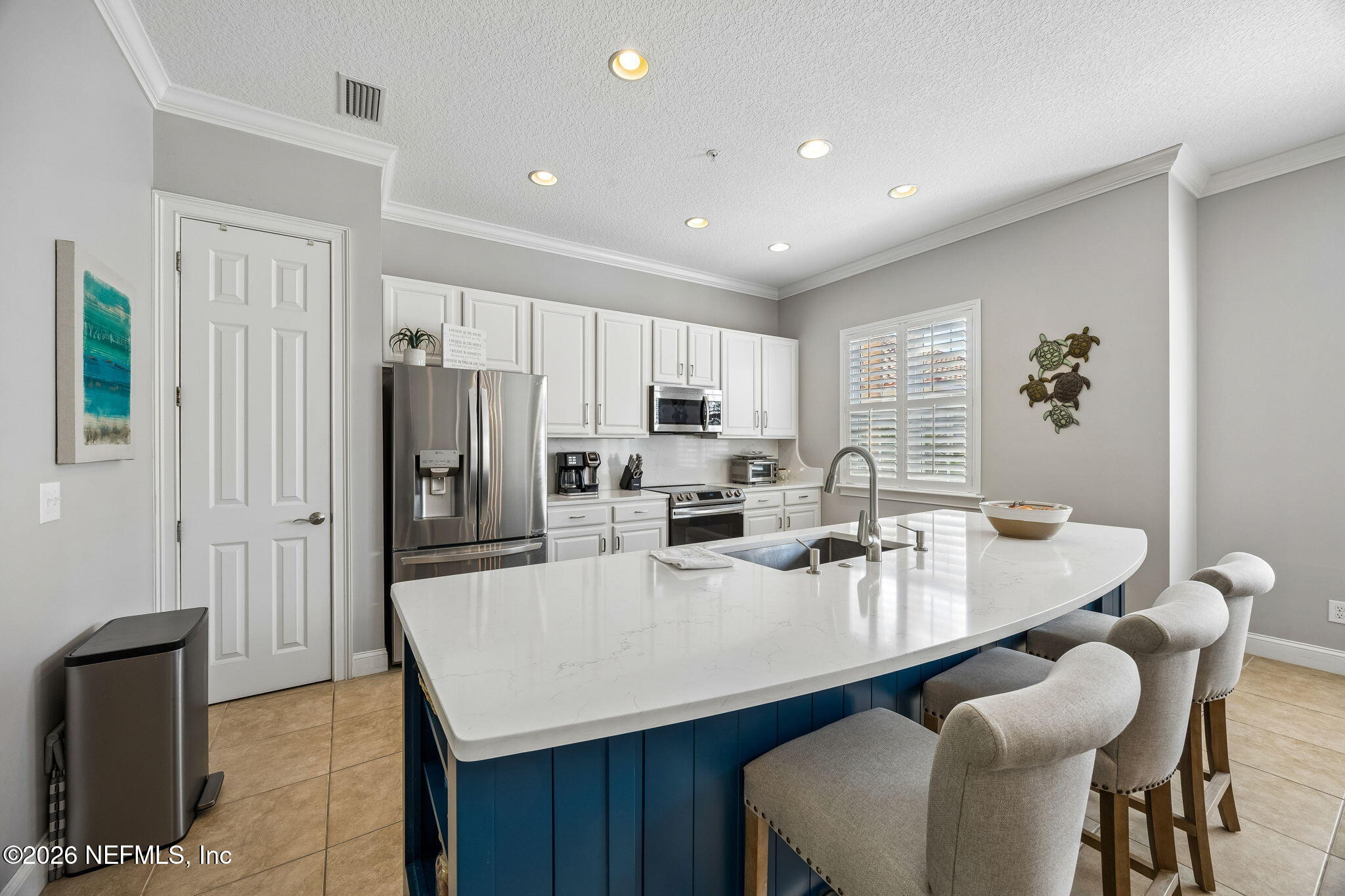 96122 Roddenberry Way Fernandina Beach, FL 32034 - Photo 8 of 39 a kitchen with refrigerator and chairs