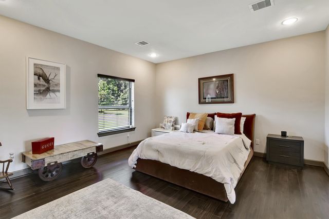 a bedroom with a bed a couch and a window