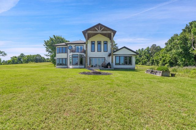 a front view of a house with a yard table and chairs