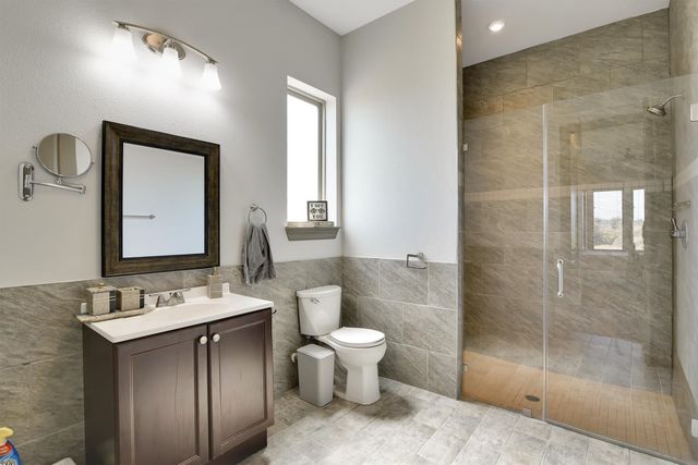 a bedroom with a bed and a ceiling fan