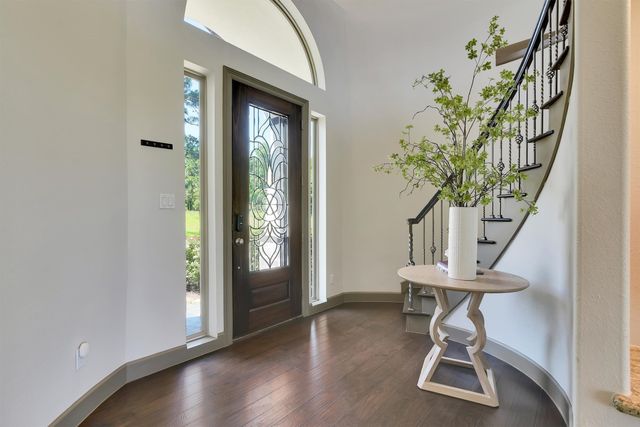 a living room with furniture dining table and a chandelier