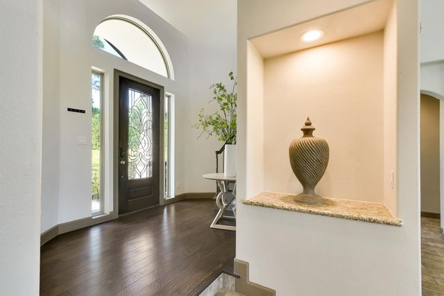 a view of living room with furniture and mirror