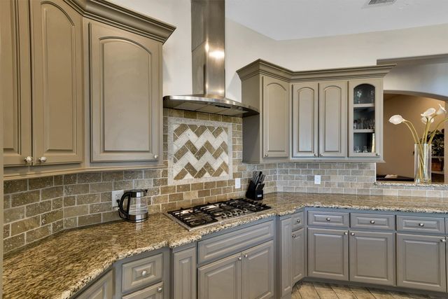 a kitchen with granite countertop a sink and cabinets