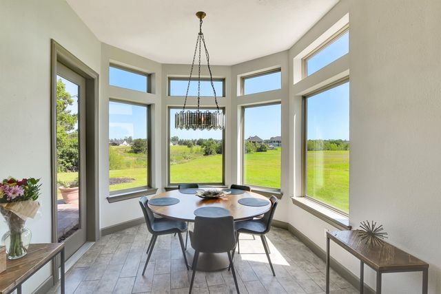 a view of a dining room with furniture large windows and wooden floor