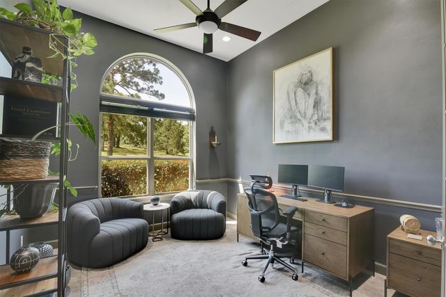a work room with furniture and a large window