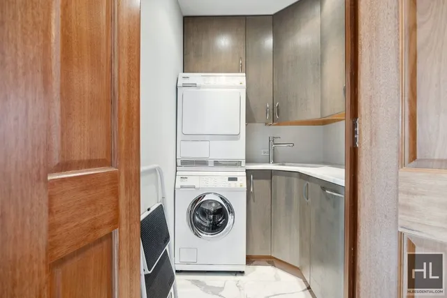 a view of walk in closet with clothes