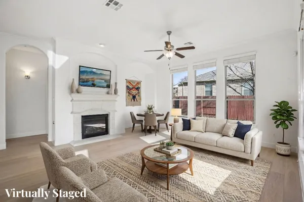 a living room with furniture a rug and a fireplace