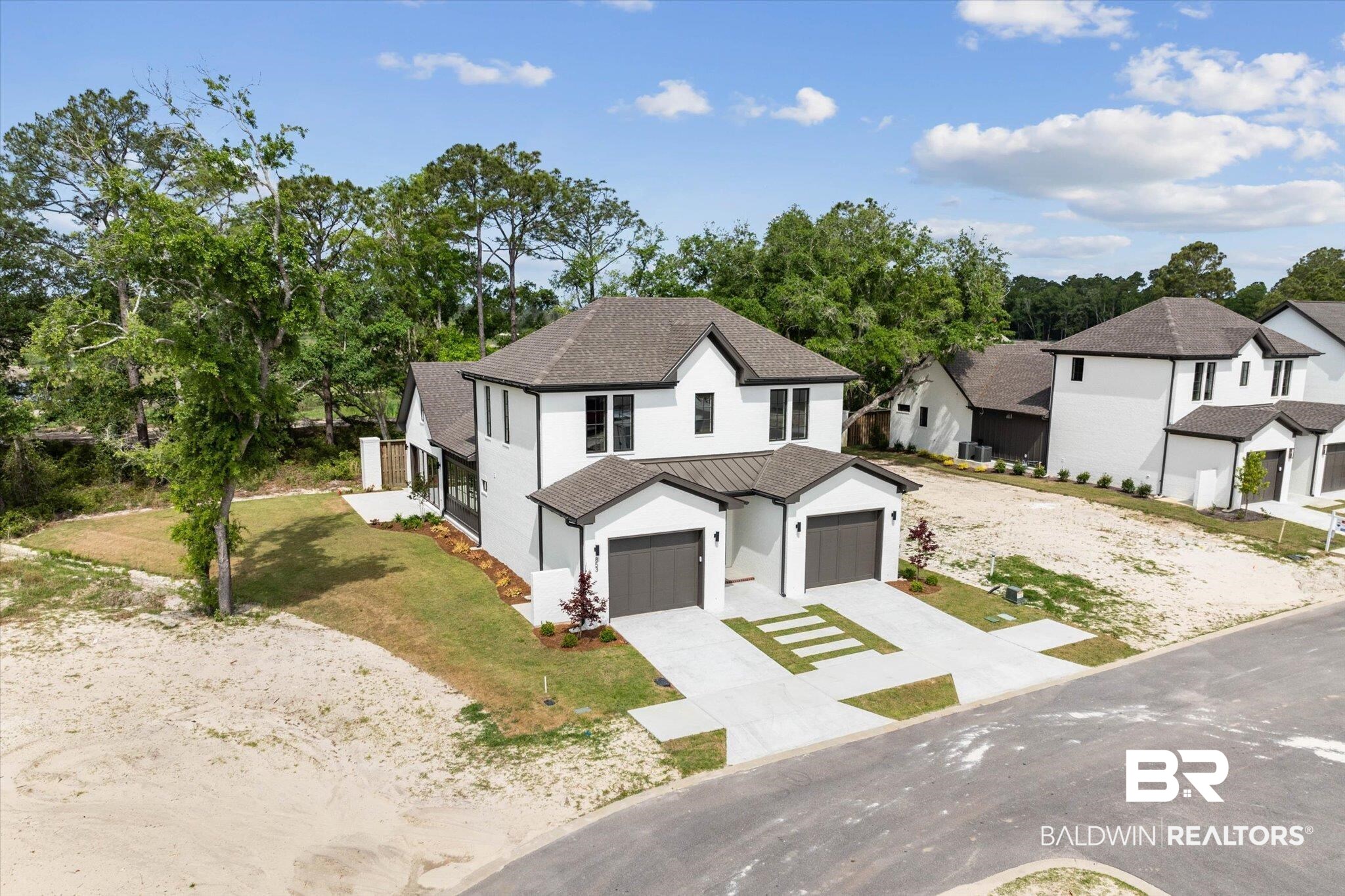 853 Inlet Circle Gulf Shores, AL 36542 - Photo 1 of 55 Modern farmhouse style home with roof with shingles, stucco siding, metal roof, a standing seam roof, and concrete driveway