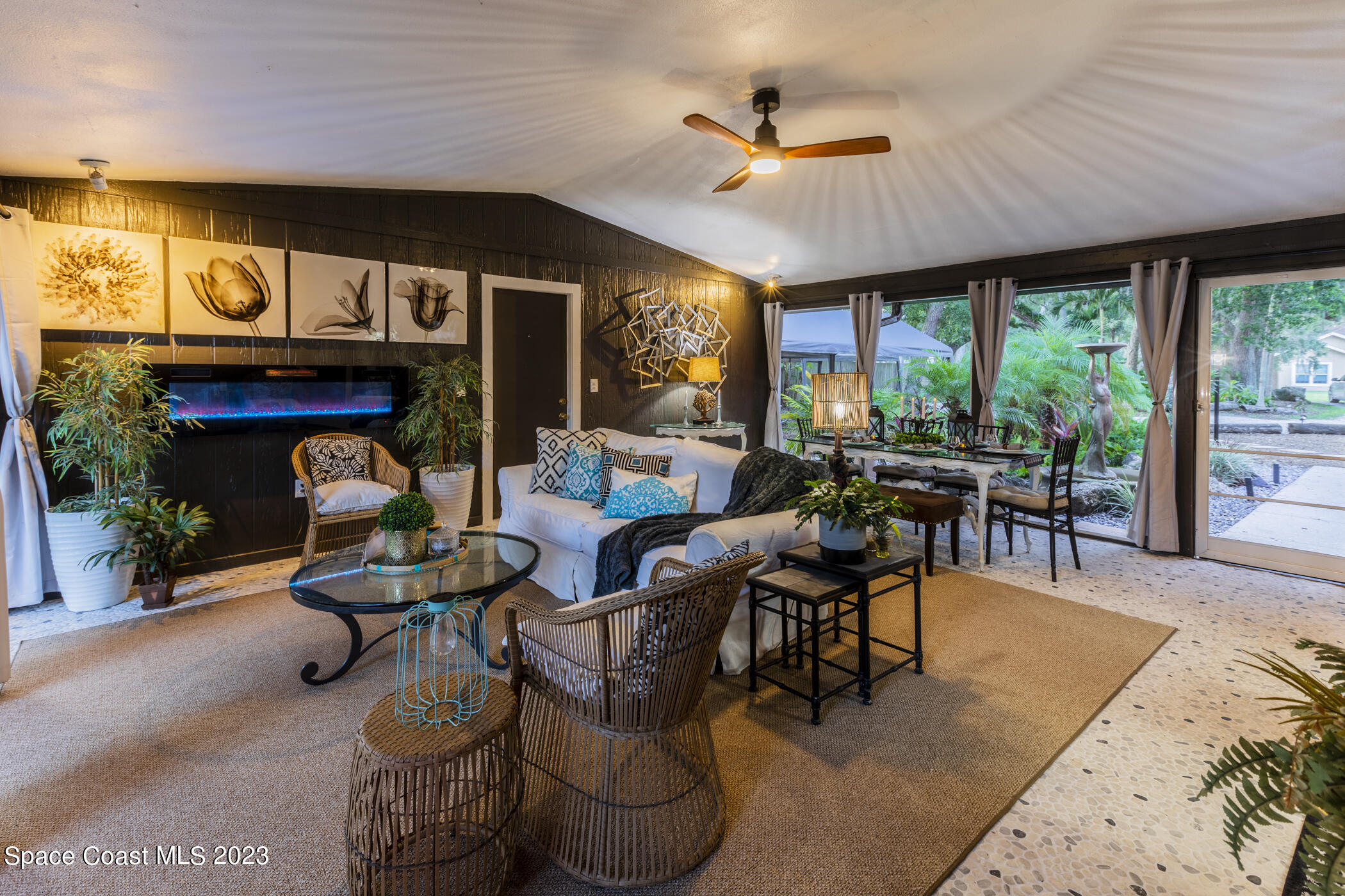 1428 Rose Court Melbourne, FL 32935 - Photo 12 of 78 a living room with furniture a fireplace and a large window