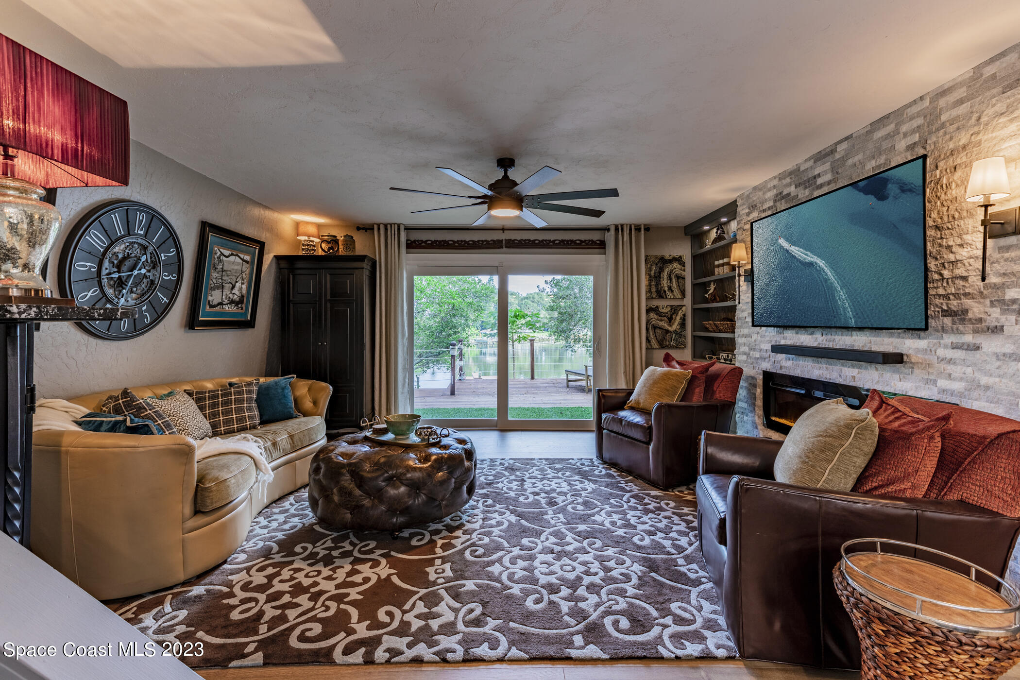 1428 Rose Court Melbourne, FL 32935 - Photo 17 of 78 a living room with furniture a flat screen tv and a large window