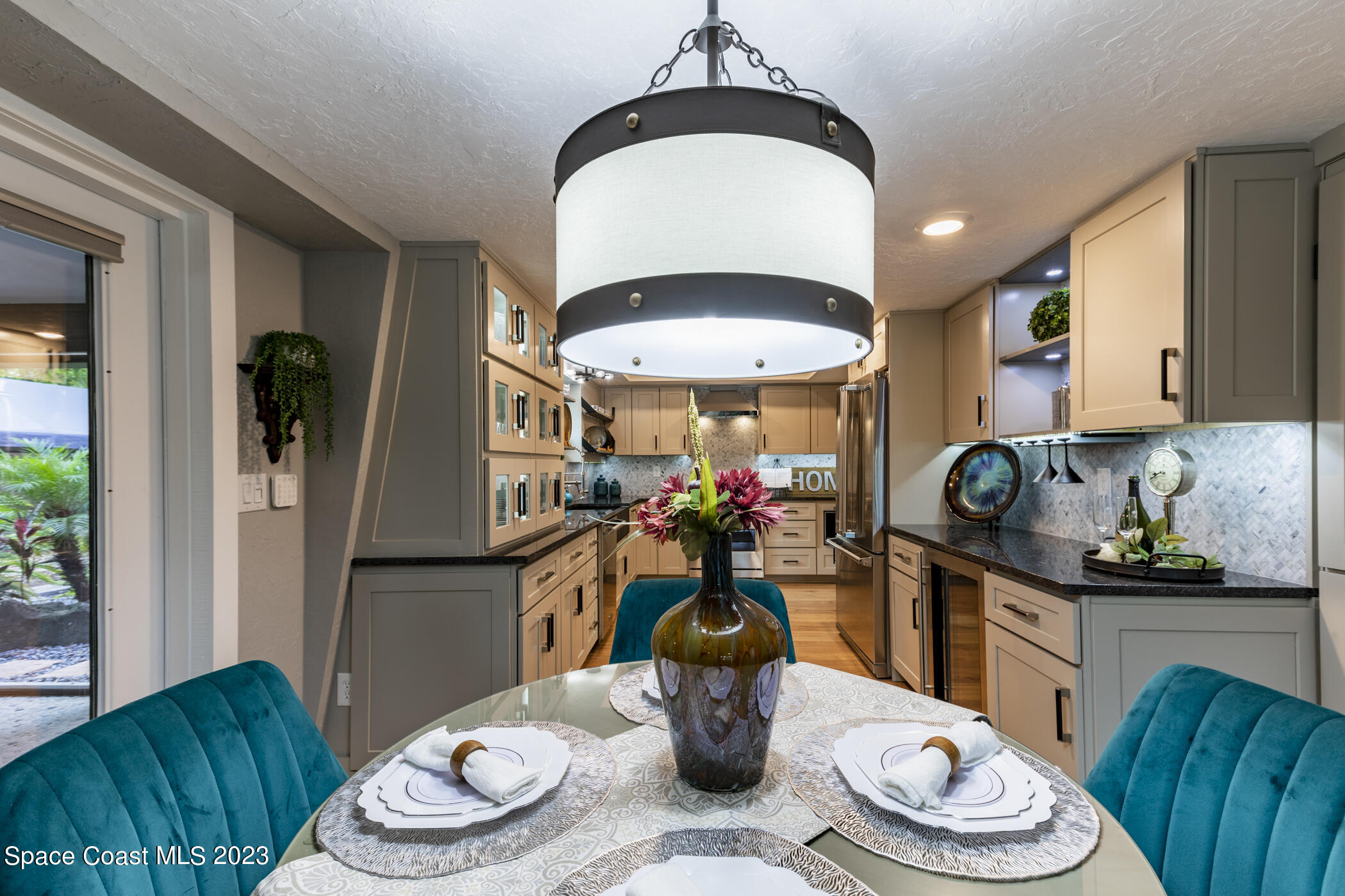 1428 Rose Court Melbourne, FL 32935 - Photo 22 of 78 a kitchen with a dining table and chairs