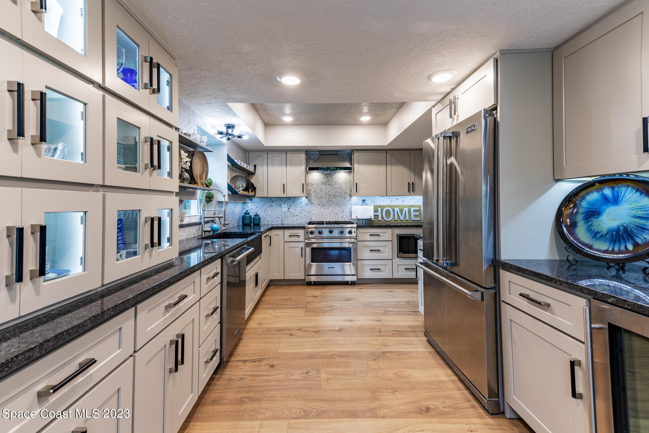 1428 Rose Court Melbourne, FL 32935 - Photo 23 of 78 a kitchen with stainless steel appliances granite countertop a refrigerator and a stove