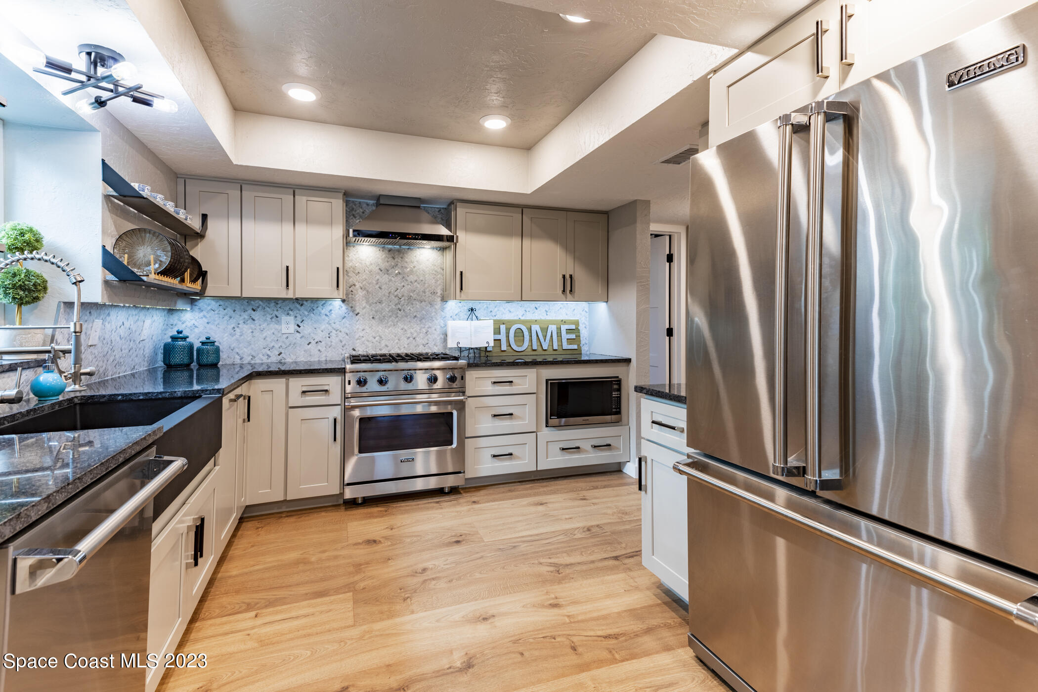 1428 Rose Court Melbourne, FL 32935 - Photo 27 of 78 a kitchen with stainless steel appliances a refrigerator sink and stove
