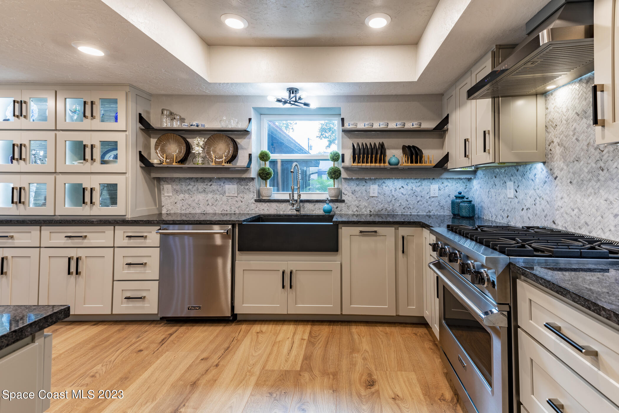 1428 Rose Court Melbourne, FL 32935 - Photo 29 of 78 a kitchen with stainless steel appliances granite countertop a stove a sink and a refrigerator