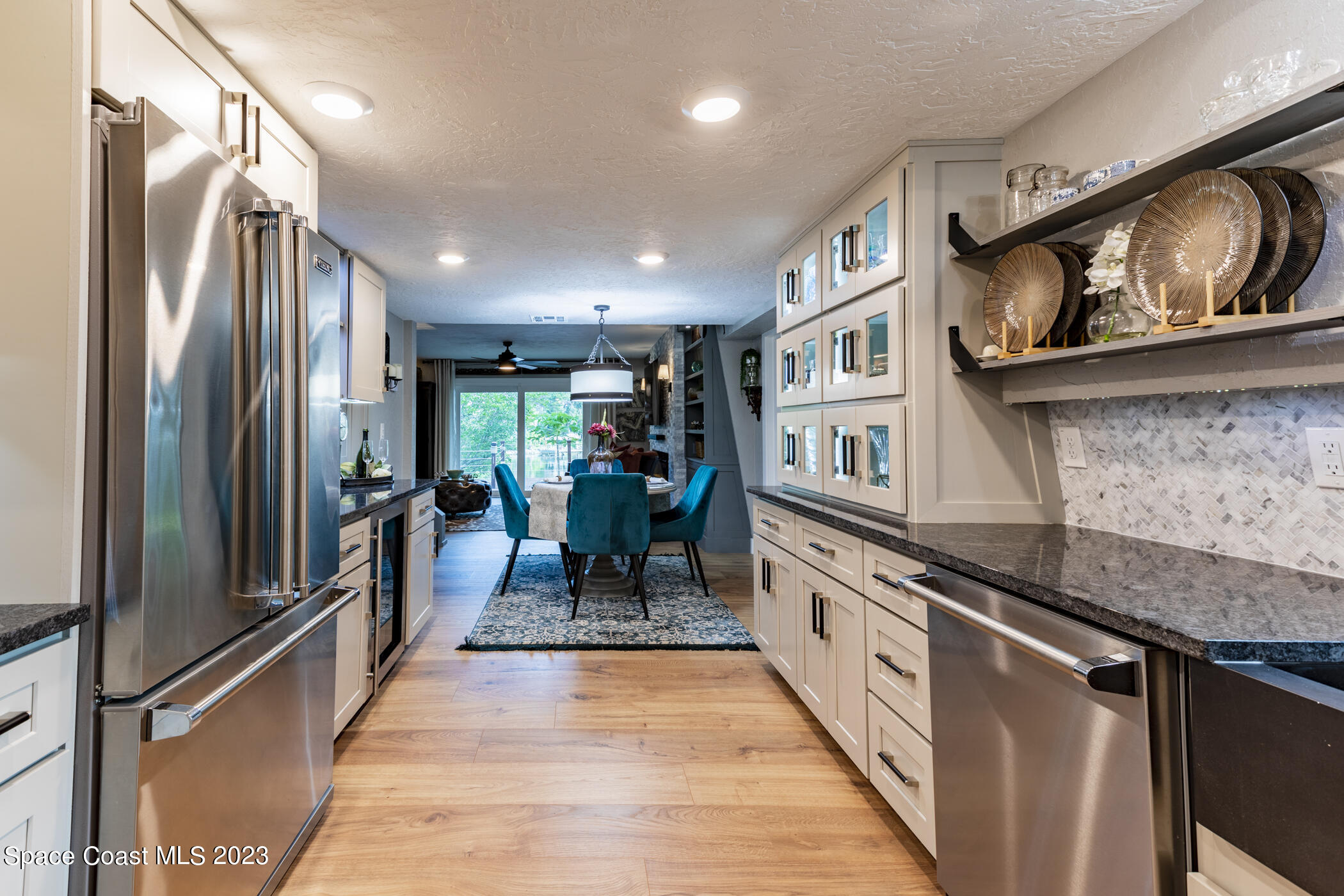 1428 Rose Court Melbourne, FL 32935 - Photo 31 of 78 a kitchen with stainless steel appliances granite countertop a refrigerator a stove and a sink