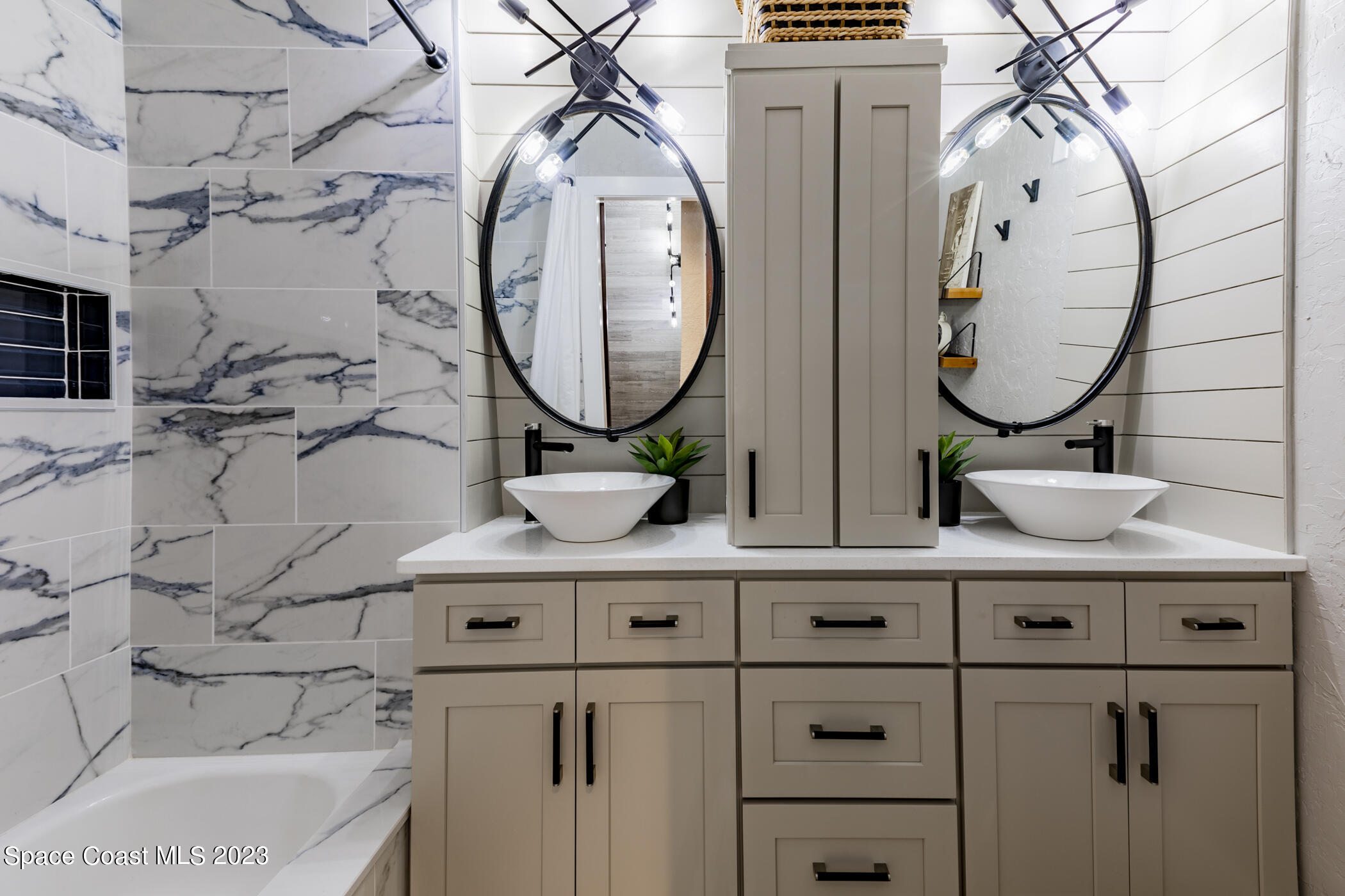 1428 Rose Court Melbourne, FL 32935 - Photo 50 of 78 a bathroom with a sink and a mirror