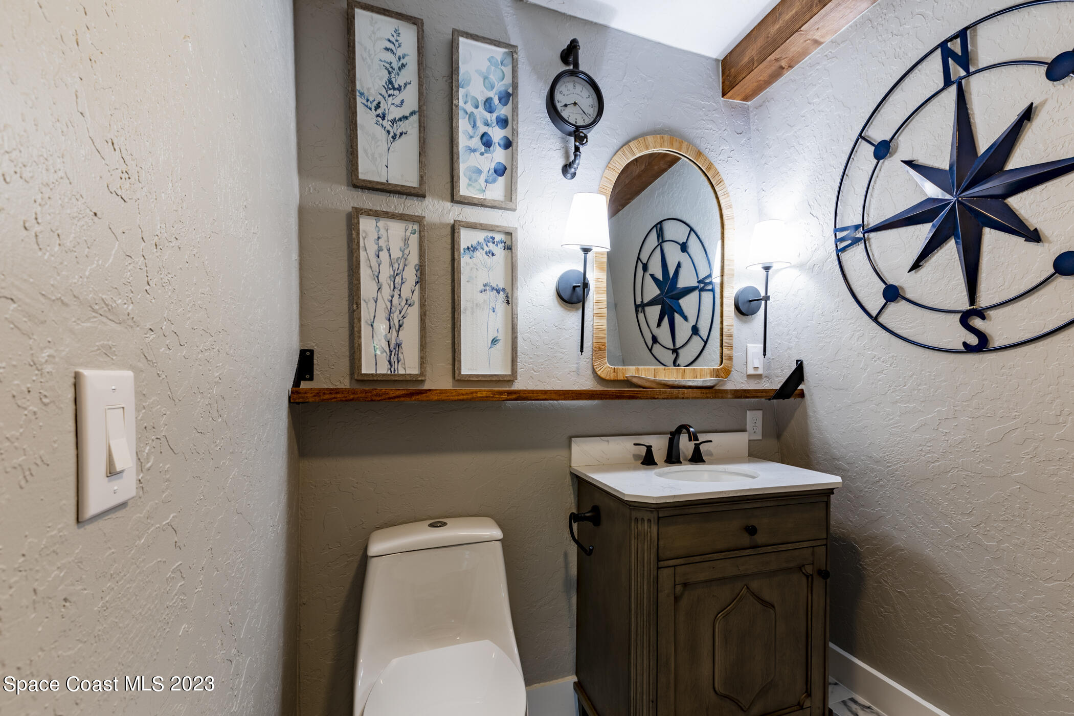 1428 Rose Court Melbourne, FL 32935 - Photo 59 of 78 a bathroom with a sink and a mirror