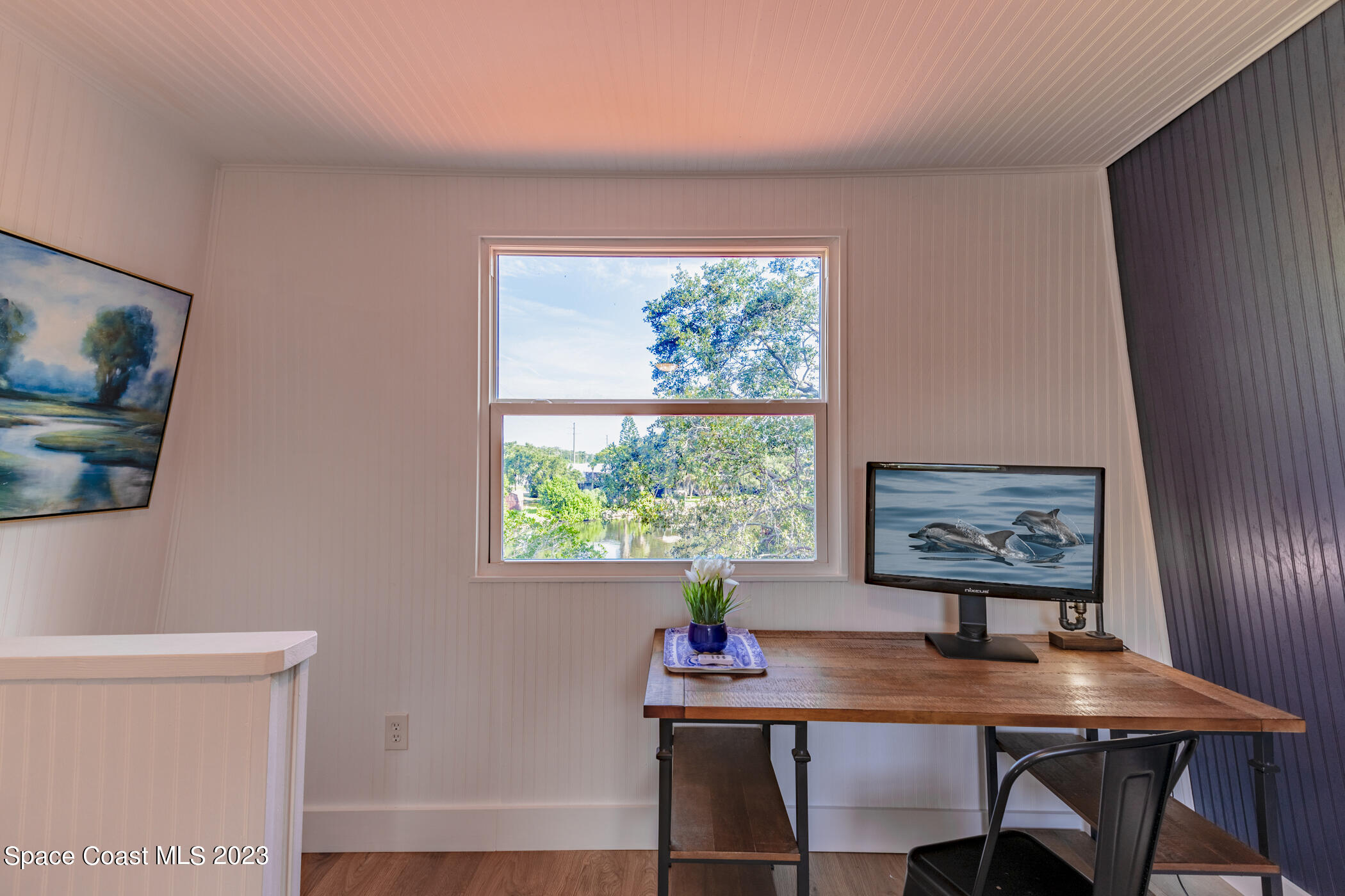 1428 Rose Court Melbourne, FL 32935 - Photo 66 of 78 a view of a workspace with furniture and a window