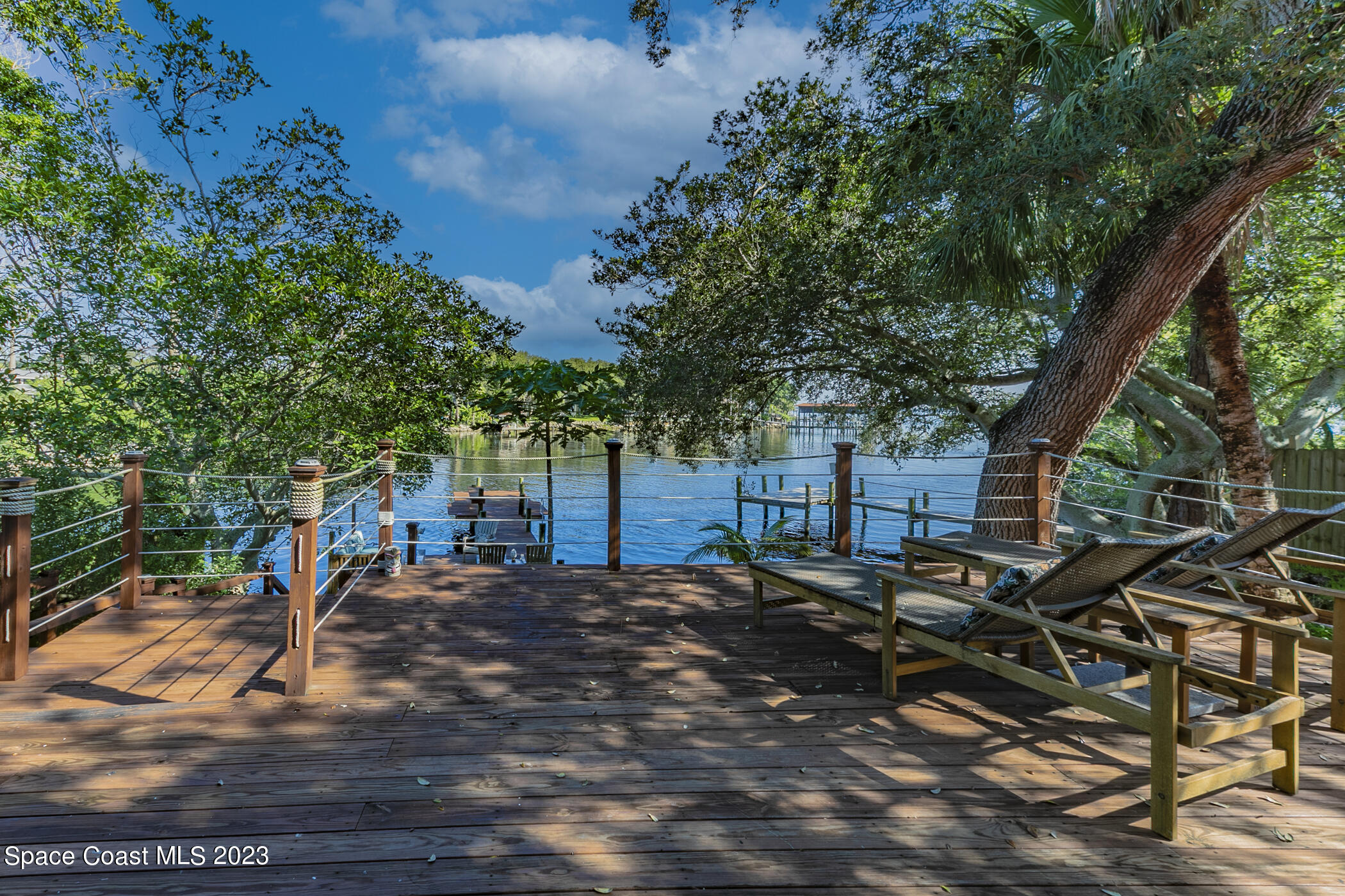 1428 Rose Court Melbourne, FL 32935 - Photo 70 of 78 a view of a patio with table and chairs with wooden floor and fence
