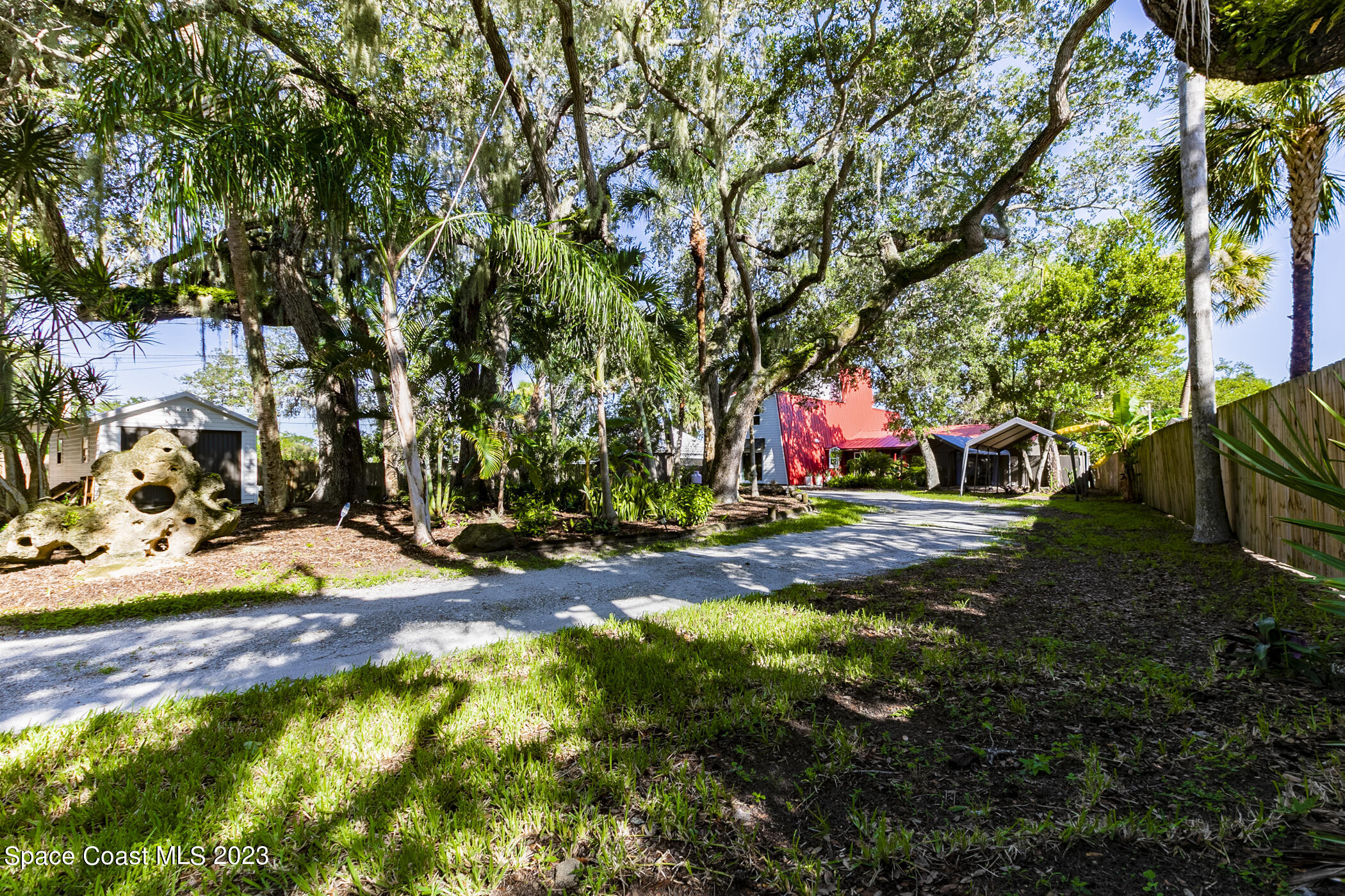 1428 Rose Court Melbourne, FL 32935 - Photo 9 of 78 a view of outdoor space with deck and tree