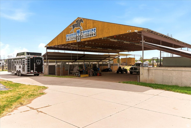 5321 South 3100th Street West Roy, UT 84067 - Photo 60 of 64 Covered equestrian facility featuring a gabled roofline, concrete paving, and an open-air design