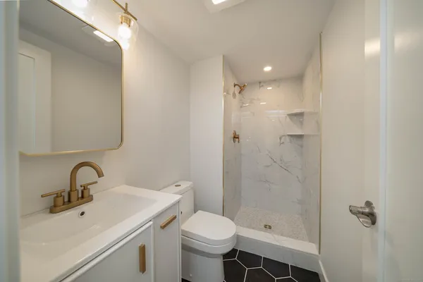 a bathroom with a sink toilet and shower