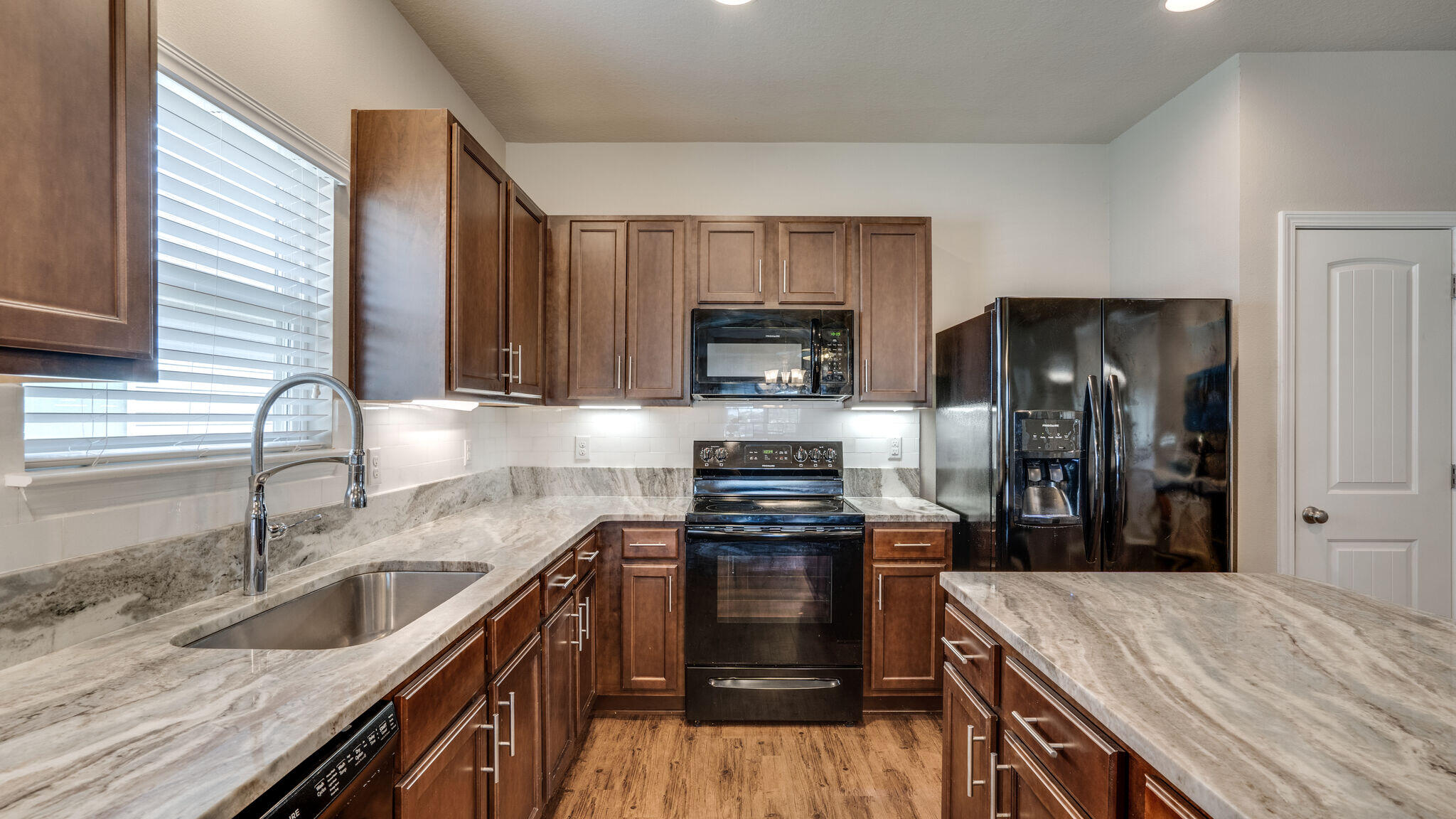 260 Cornelia Street Freeport, FL 32439 - Photo 11 of 42 a kitchen with a sink stove and refrigerator