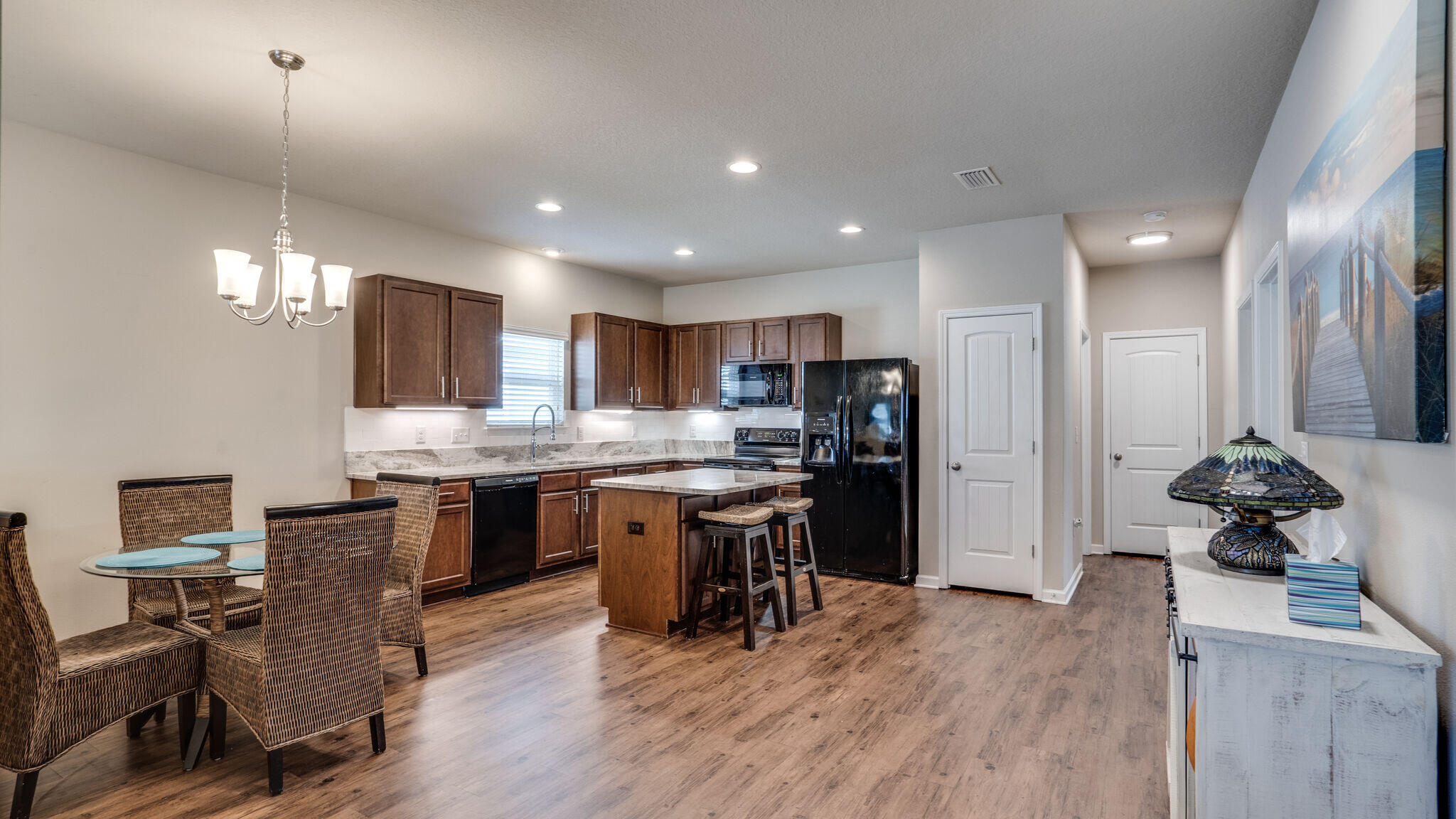 260 Cornelia Street Freeport, FL 32439 - Photo 13 of 42 a kitchen with stainless steel appliances kitchen island granite countertop a stove refrigerator and cabinets