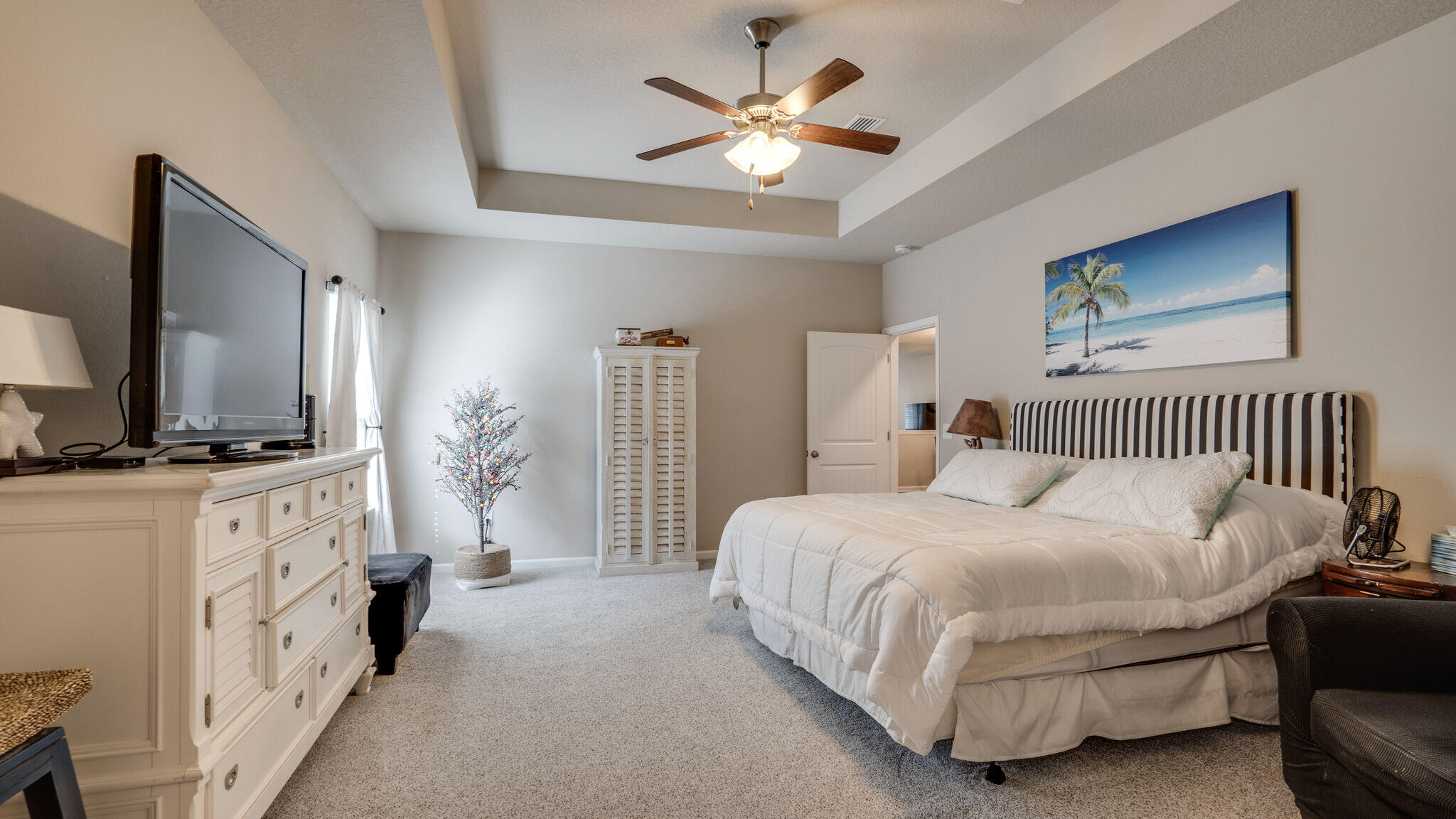 260 Cornelia Street Freeport, FL 32439 - Photo 17 of 42 a bedroom with bed couches and a flat tv screen