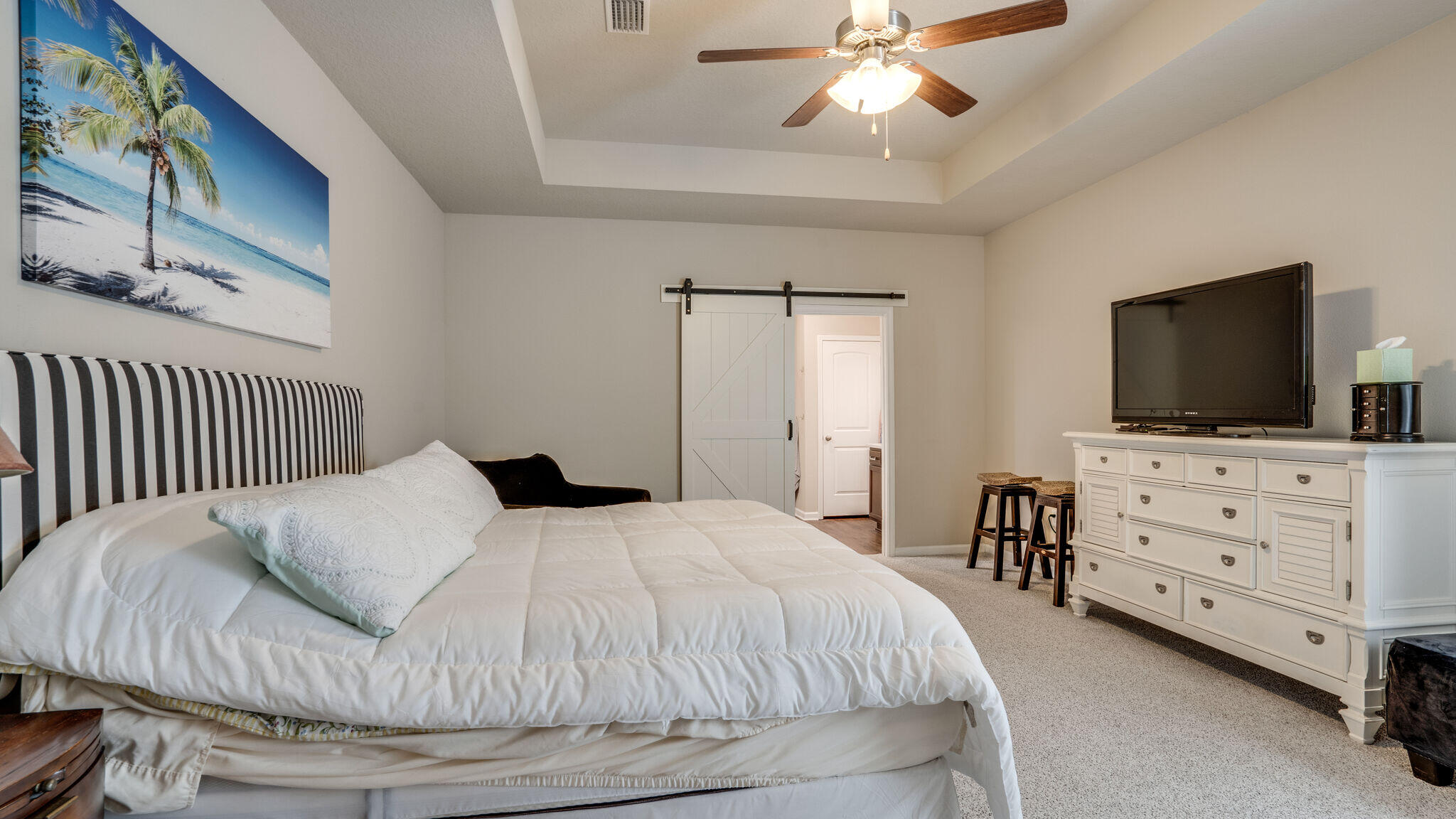 260 Cornelia Street Freeport, FL 32439 - Photo 19 of 42 a bedroom with a bed and flat screen tv