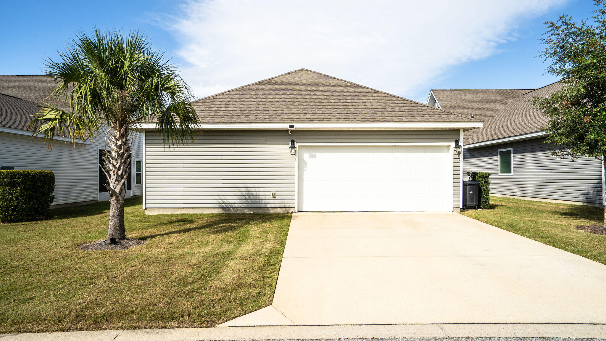 260 Cornelia Street Freeport, FL 32439 - Photo 25 of 42 a small white house with a yard plants and large tree