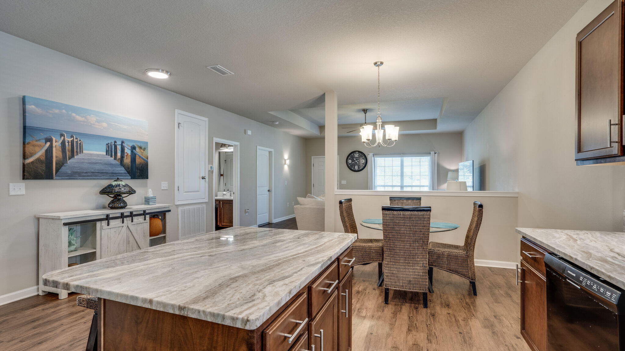 260 Cornelia Street Freeport, FL 32439 - Photo 9 of 42 a view of a dining room with furniture a kitchen and chandelier