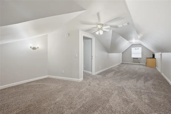 an empty room with a ceiling fan and entryway