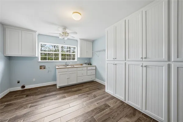 a kitchen with granite countertop white cabinets and window