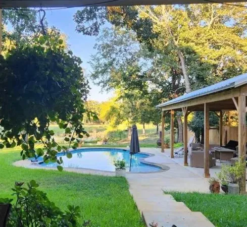 a view of a chair and table in the garden