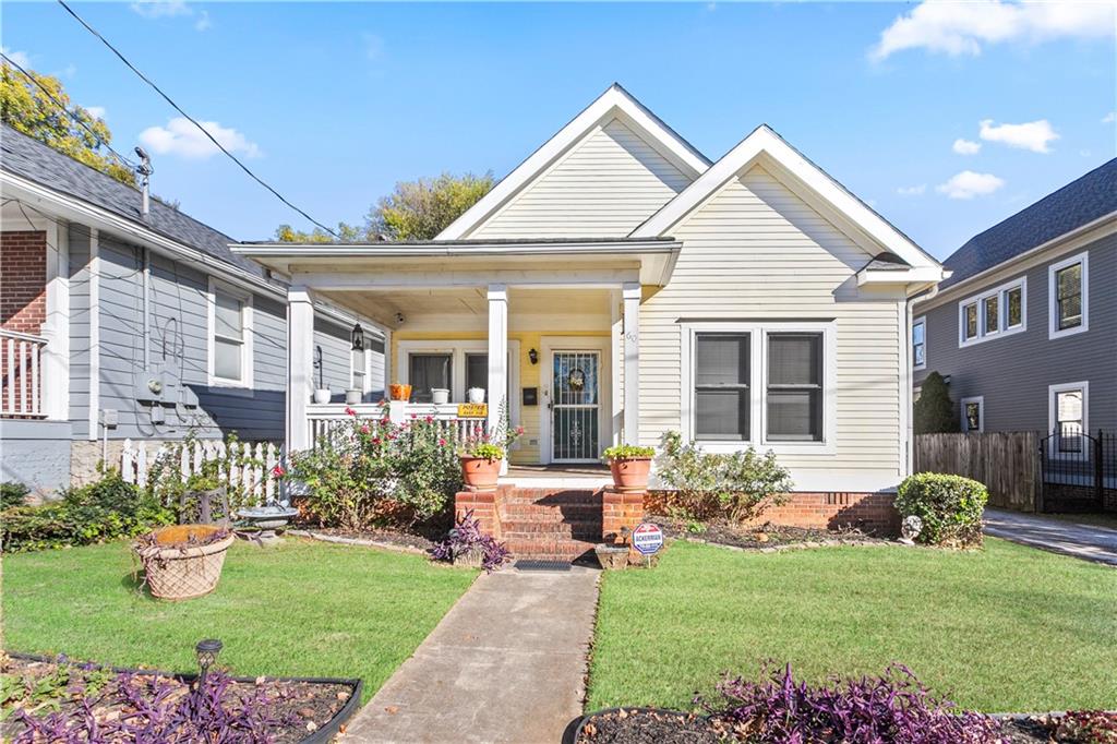 a front view of a house with garden and porch
