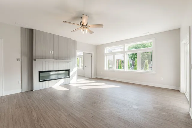 a view of an empty room with a window and fireplace