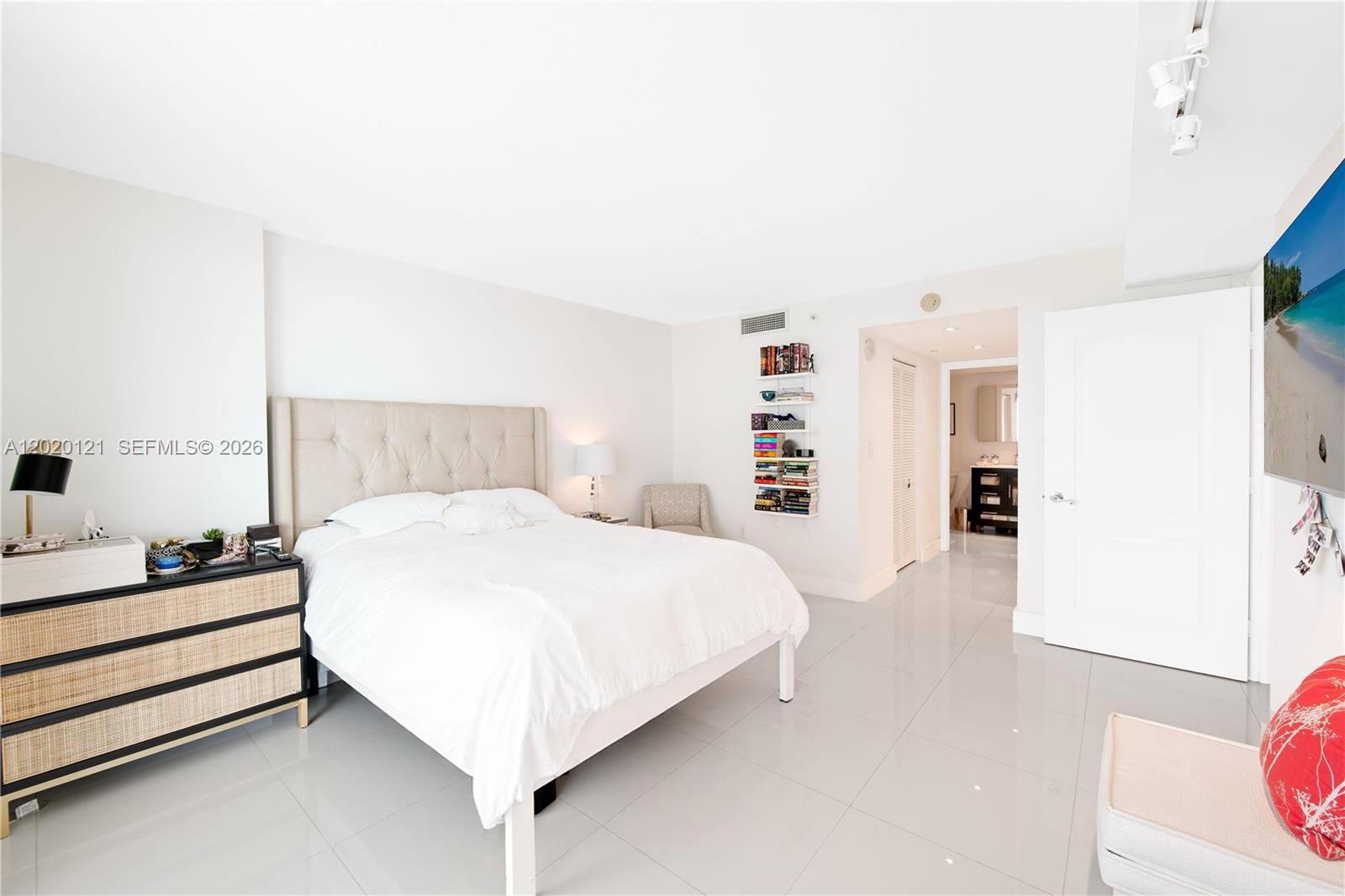 2101 Brickell Avenue, Unit 1909 Miami, FL 33129 - Photo 11 of 25 a bedroom with a bed and a lamp on the dresser