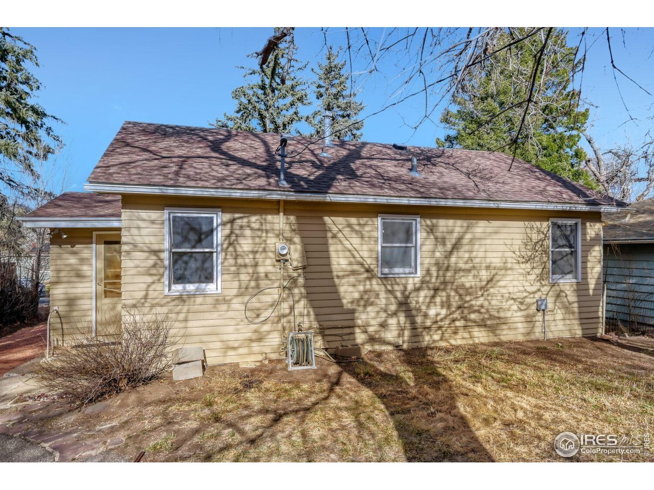 534 Dewey Avenue Boulder, CO 80304 - Photo 3 of 18 a view of a stone house with a yard